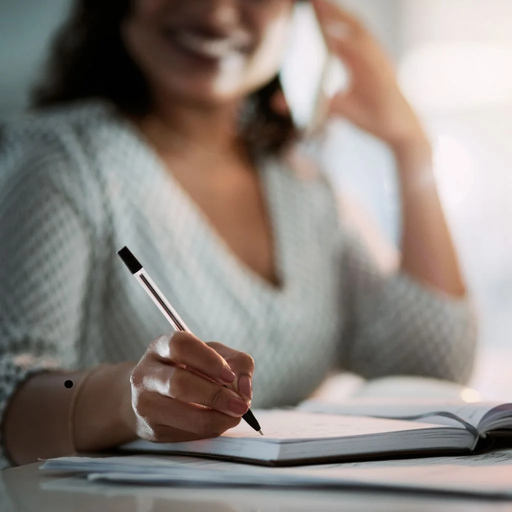 a-person-sitting-at-a-desk-with-a-pen-and-notebook