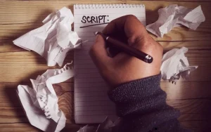 a-hand-holding-pencil-and-writing-b2b-telemarketing-scripts