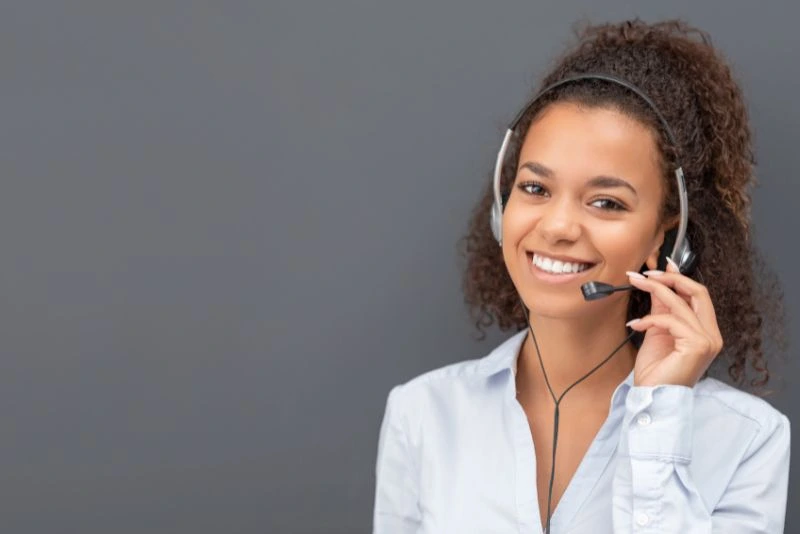 a-person-wearing-a-headset-and-smiling-while-talking-on-the-phone