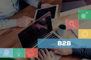 Two-people-working-on-laptops-with-the-words-b2b-marketing