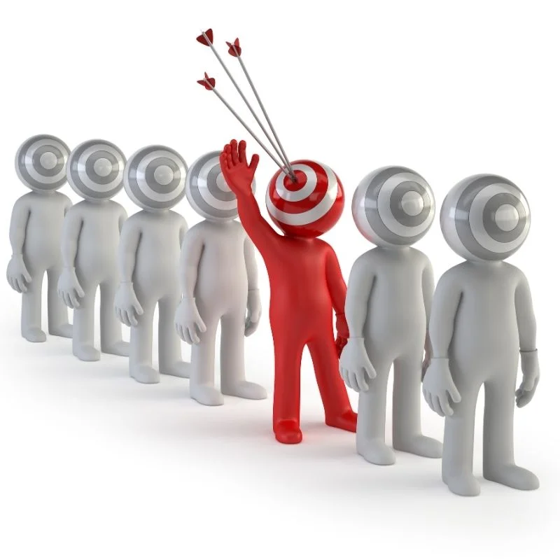 a-person-is-standing-in-front-of-a-group-of-people-with-a-target-on-their-head