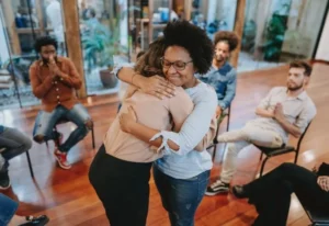 Two people hugging in a group of people